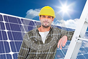 Composite image of smiling handyman in overalls leaning on ladder