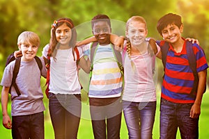 Composite image of smiling little school kids in school corridor