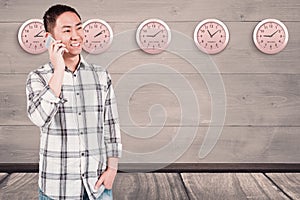 Composite image of smiling man using his smartphone