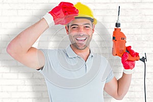 Composite image of smiling manual worker holding drill machine