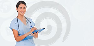 Composite image of smiling nurse writing