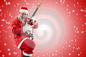 Composite image of smiling santa claus playing guitar while dancing