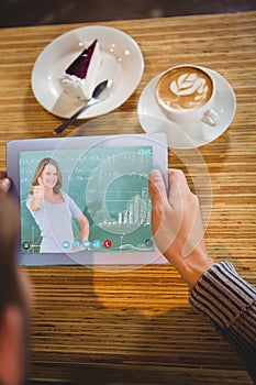 Composite image of smiling teacher gesturing thumbs up in front of blackboard