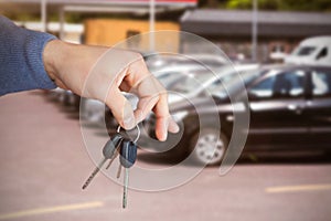 Composite image of smiling woman receiving keys from somebody