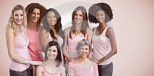 Composite image of smiling women in pink outfits posing for breast cancer awareness