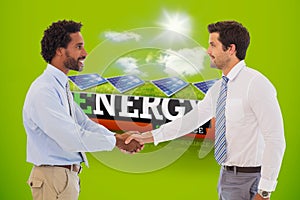 Composite image of smiling young businessmen shaking hands in office