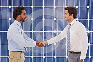 Composite image of smiling young businessmen shaking hands in office