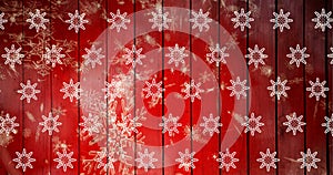 Composite image of snowflakes pattern on wooden background with copy space