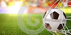 Composite image of soccer ball in goal net
