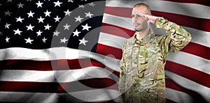 Composite image of soldier giving salute