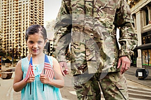 Composite image of soldier reunited with his daughter