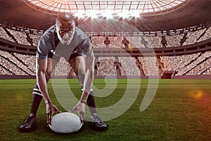 Composite image of sportsman holding ball while playing rugby with 3d