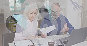 Composite image of statistical data processing against senior caucasian couple calculating finances