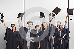 Composite image of students holding mortarboards