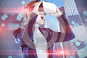 Composite image of surprised young businesswoman wearing vr glasses