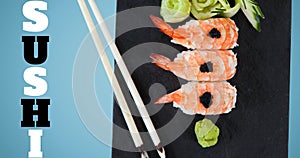 Composite image of sushi with chopsticks by text on blue background, copy space