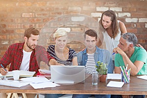 Composite image of teamwork using laptop together