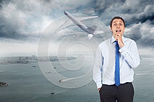 Composite image of thinking businessman touching his chin