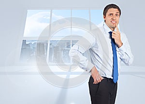 Composite image of thinking businessman touching his chin