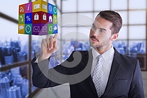Composite image of thoughtful businessman pointing cube with his finger