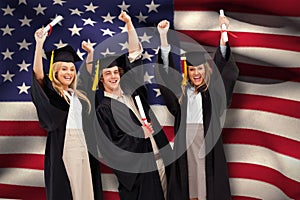 Composite image of three students in graduate robe raising their arms