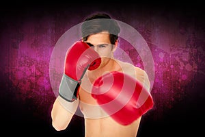 Composite image of tough man wearing red boxing gloves punching to camera