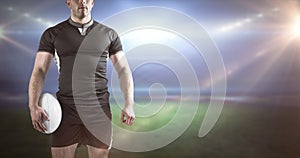 Composite image of tough rugby player holding ball