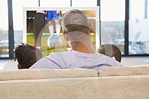 Composite image of two children sitting on sofa with their father