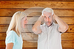 Composite image of unhappy couple having an argument with man not listening