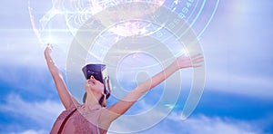 Composite image of woman with arms raised looking through virtual reality simulator against white ba
