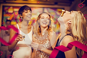 Composite image of woman balancing shot glass on her mouth