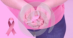 Composite image of woman with breast cancer awareness ribbon