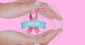 Composite image of woman with breast cancer awareness slogan and ribbon on pink background