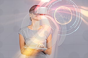 Composite image of woman holding digital tablet and using virtual reality headset