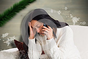 Composite image of woman suffering from a migrane