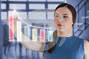 Composite image of woman touching virtual graph