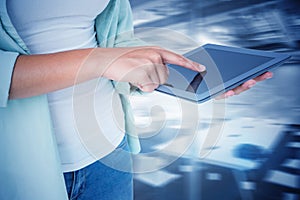 Composite image of woman using tablet pc