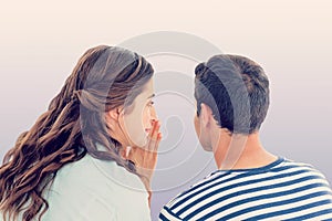 Composite image of woman whispering secret to boyfriend