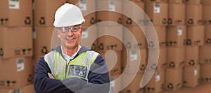 Composite image of worker wearing hard hat in warehouse