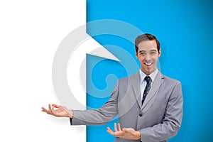 Composite image of young businessman presenting something with speech bubble