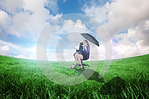 Composite image of young businesswoman holding umbrella