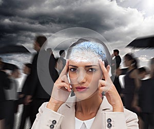 Composite image of young businesswoman putting her fingers on her temples