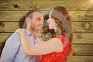 Composite image of young couple looking at each other and embracing
