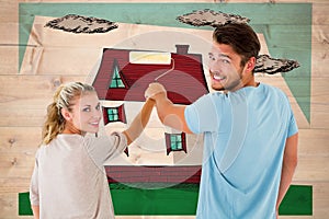 Composite image of young couple painting with roller