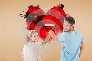 Composite image of young couple painting with roller