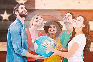 Composite image of young creative business people with a globe