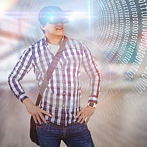 Composite image of young man with hand on hop wearing virtual reality simulator glasses