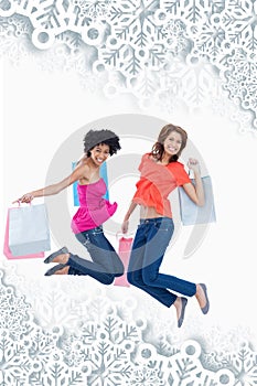 Composite image of young teenagers energetically jumping after going shopping