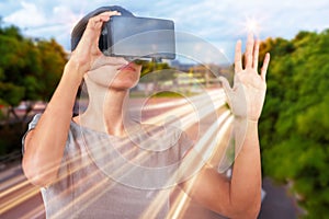 Composite image of young woman wearing virtual video glasses