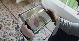 Composite of man sitting at home watching hockey match on tablet